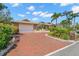 Beautiful home featuring a brick driveway and lush landscaping, providing an inviting and well-maintained exterior at 852 3Rd Ave S, Tierra Verde, FL 33715