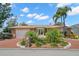 Inviting home featuring a brick driveway, lush landscaping, and beautiful curb appeal, complete with palm trees at 852 3Rd Ave S, Tierra Verde, FL 33715