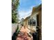 Side exterior brick-paved walkway of home with windows and tropical plants at 852 3Rd Ave S, Tierra Verde, FL 33715