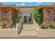 Charming home entrance with stone accents, tiled steps, and lush landscaping creating a warm and inviting curb appeal at 852 3Rd Ave S, Tierra Verde, FL 33715