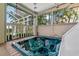 Screened-in patio with a modern hot tub and views of the tropical landscaping at 852 3Rd Ave S, Tierra Verde, FL 33715
