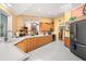 Bright kitchen with light wood cabinets, white countertops, and stainless steel appliances at 852 3Rd Ave S, Tierra Verde, FL 33715