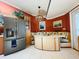 Eat-in kitchen with stainless steel refrigerator, built-in booth, and decorative pendant lighting at 852 3Rd Ave S, Tierra Verde, FL 33715
