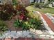 Eye-catching flower beds along a brick walkway enhance the curb appeal at 852 3Rd Ave S, Tierra Verde, FL 33715