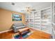 Cozy living room with hardwood floors, couch, and large built-in bookshelves at 852 3Rd Ave S, Tierra Verde, FL 33715