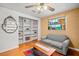 Inviting living room features built-in shelving, a cozy sofa, hardwood floors, and a colorful stained-glass window at 852 3Rd Ave S, Tierra Verde, FL 33715