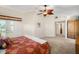 Inviting main bedroom with a ceiling fan, neutral carpet, and access to the outdoors at 852 3Rd Ave S, Tierra Verde, FL 33715