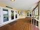 Expansive covered patio with wooden floors, offering ample space for outdoor seating and entertaining at 852 3Rd Ave S, Tierra Verde, FL 33715