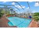 Sparkling screened pool offers waterfront views with lush landscaping, creating a tranquil oasis at 852 3Rd Ave S, Tierra Verde, FL 33715