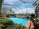 Relaxing screened-in pool with beautiful water views and lush landscaping at 852 3Rd Ave S, Tierra Verde, FL 33715