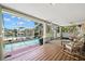 Expansive screened-in pool patio with comfortable seating offers stunning views of the waterfront and canal at 852 3Rd Ave S, Tierra Verde, FL 33715