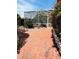 Enclosed pool area surrounded by tropical landscaping and brick-paved walkways at 852 3Rd Ave S, Tierra Verde, FL 33715