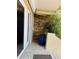 Inviting porch with stone accent wall, tile floor, and lush greenery, perfect for relaxing outdoors at 852 3Rd Ave S, Tierra Verde, FL 33715