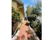 Brick walkway on the side of the home featuring mature landscaping at 852 3Rd Ave S, Tierra Verde, FL 33715