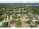 Aerial view of a house in a neighborhood surrounded by lush trees and greenery at 4318 River Birch Dr, Spring Hill, FL 34607