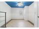 Bedroom with white walls, blue ceiling and tile flooring at 4318 River Birch Dr, Spring Hill, FL 34607
