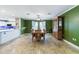 This elegant dining room features bright green walls, a wooden table with chairs, and a classic china cabinet at 4318 River Birch Dr, Spring Hill, FL 34607