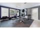 Home gym featuring gym equipment, mirrors, and ample lighting for an invigorating workout space at 4318 River Birch Dr, Spring Hill, FL 34607