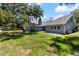 Charming home with a large yard and mature shade trees creating a serene outdoor space at 4318 River Birch Dr, Spring Hill, FL 34607