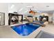 Expansive indoor pool area with natural light, a unique bridge feature, and gazebo seating at 4318 River Birch Dr, Spring Hill, FL 34607
