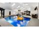 Stunning indoor pool featuring a fun rubber duck, natural lighting, and cozy gazebo seating at 4318 River Birch Dr, Spring Hill, FL 34607