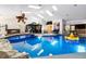 Beautiful indoor pool area featuring gazebo seating, a fish tank, and a seamless blend of relaxation and entertainment at 4318 River Birch Dr, Spring Hill, FL 34607