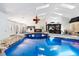 Inviting indoor pool area with skylights, gazebo seating, and a charming bridge walkway at 4318 River Birch Dr, Spring Hill, FL 34607