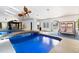 Amazing indoor pool area featuring natural lighting, a relaxing swing set, and a unique walkway at 4318 River Birch Dr, Spring Hill, FL 34607