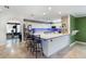 Spacious kitchen featuring white cabinets, a large island with seating, and modern stainless steel appliances at 4318 River Birch Dr, Spring Hill, FL 34607