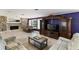 Spacious living room with a stone fireplace, comfortable seating, and a large entertainment center at 4318 River Birch Dr, Spring Hill, FL 34607