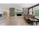 Cozy living room features a stone fireplace and large windows at 4318 River Birch Dr, Spring Hill, FL 34607
