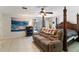 Bedroom with bed, couch and tile floors at 4318 River Birch Dr, Spring Hill, FL 34607