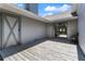 Enclosed patio features a sliding glass door and a barn door for additional storage at 4318 River Birch Dr, Spring Hill, FL 34607