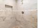 Bathroom shower with stone tile and built-in shelves at 4318 River Birch Dr, Spring Hill, FL 34607