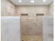 Bathroom shower with stone tile and built-in shelves at 4318 River Birch Dr, Spring Hill, FL 34607