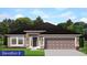 Charming single-story home featuring neutral paint, a dark roof, an attached two-car garage, and manicured landscaping at 4841 Sutherland St # Lot 58, Spring Hill, FL 34609