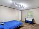 Cozy bedroom with wood floors, track lighting, and a comfortable sitting area at 6008 Angus Valley Dr, Wesley Chapel, FL 33544