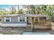 Charming home featuring a cozy front porch and well-maintained siding in a peaceful, wooded setting at 6008 Angus Valley Dr, Wesley Chapel, FL 33544
