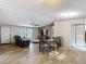 Bright and airy living area featuring laminate flooring, a ceiling fan, and an open layout at 6008 Angus Valley Dr, Wesley Chapel, FL 33544