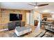 Stylishly decorated living room with wood paneling, modern furnishings, and an open floor plan at 6008 Angus Valley Dr, Wesley Chapel, FL 33544
