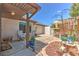 Private backyard with patio, seating area, bird feeder and landscaping at 7102 Silvermill Dr, Tampa, FL 33635