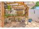 Landscaped backyard with patio area, garden trellis, and various potted plants at 7102 Silvermill Dr, Tampa, FL 33635