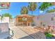 Well-maintained backyard patio area with garden trellis and landscaping at 7102 Silvermill Dr, Tampa, FL 33635