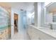 Bathroom boasts double sinks, white cabinetry, modern fixtures, and access to a walk-in closet at 7102 Silvermill Dr, Tampa, FL 33635