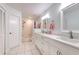 Bright bathroom with white tile, double sinks, white cabinets, and shower tub combo at 7102 Silvermill Dr, Tampa, FL 33635