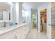 Bathroom boasts double sinks, white cabinetry, modern fixtures, and access to the bedroom at 7102 Silvermill Dr, Tampa, FL 33635