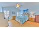 Bright bedroom features a ceiling fan, light hardwood floors, and beach-themed décor at 7102 Silvermill Dr, Tampa, FL 33635