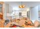 Eat-in kitchen area featuring a dining table with seating and modern light fixture at 7102 Silvermill Dr, Tampa, FL 33635
