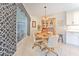 Cozy dining area with a wooden table, hutch, and a view of the screened-in porch at 7102 Silvermill Dr, Tampa, FL 33635