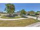 Well-manicured front yard with a mature trees and driveway at 7102 Silvermill Dr, Tampa, FL 33635